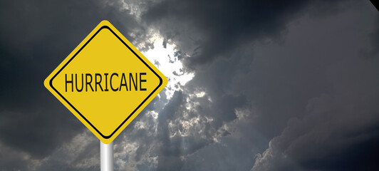 Hurricane season with symbol sign against a stormy background and copy space. dirty and angled sign adds to the drama. hurricane sign, hurricane season sing on cloudy background