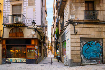 Looking down from Baixada de la Llibreteria street on the long narrow Carrer de la Dagueria full of...