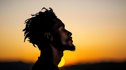 Silhouette of a man against a sunset, evoking feelings of peace and reflection.