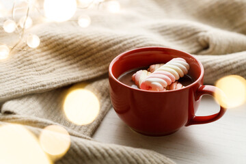 Cup of delicious hot chocolate on wooden table background.