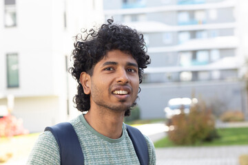 portrait of a young man with backpack in the city