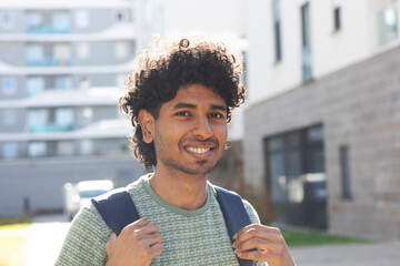 portrait of a young man with backpack in the city
