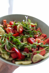 Vibrant Salad with Tomatoes, Cucumbers, Arugula, and Red Onions