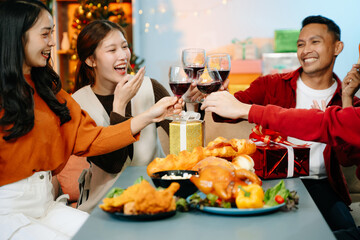 Friends celebrate Christmas with gift exchanges, festive food, and laughtera perfect scene for holiday and New Year