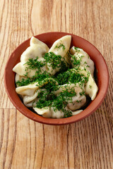 boiled dumplings sprinkled with herbs in a bowl