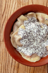dumplings with berries and sauce in a bowl