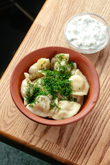 boiled dumplings sprinkled with herbs in a bowl