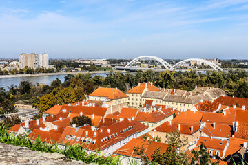 cityscape of Novi Sad from the historic vantage point of Petrovaradin, where ancient towers and...