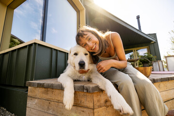 A joyful moment shared between a woman and her dog, capturing the essence of happiness and...