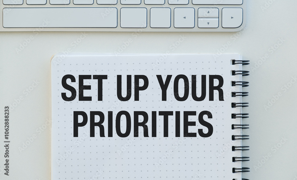 Poster a notebook with the words set up your priorities written on it
