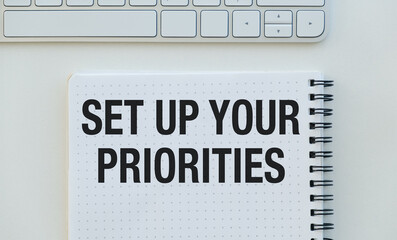 A notebook with the words Set Up Your Priorities written on it