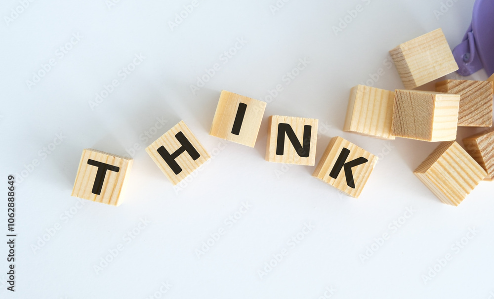 Poster a pile of wooden blocks with the word think written on them