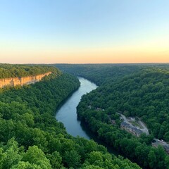Scenic overlook of a winding river valley at sunset.