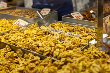 Pile of peeled walnuts ready for sale on the marketplace. Raw walnut nuts for sale at local city farmers market