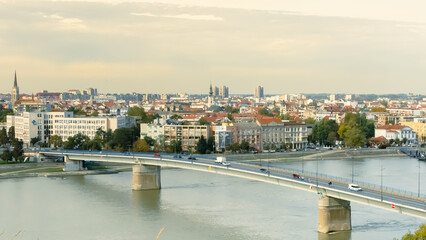 Obraz premium cityscape of Novi Sad from the historic vantage point of Petrovaradin, where ancient towers and charming streets intertwine with the gentle flow of the Danube.