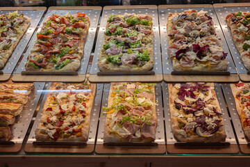 Two Racks of Freshly Baked Pizzas with various Toppings