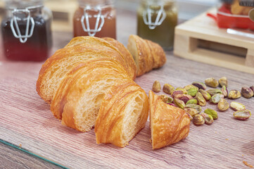 Sliced Italian Breakfast Pastries, Pistachios and Jams on the Table