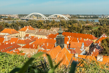 cityscape of Novi Sad from the historic vantage point of Petrovaradin, where ancient towers and...