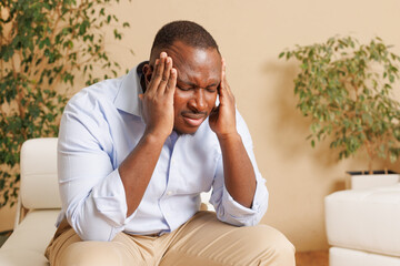 Stressed Man Holding Head in Discomfort