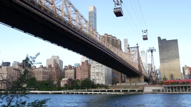 New York City Roosevelt Island tramway to Manhattan Midtown streets. American cable tram near Queensboro Bridge. Urban public transport in USA. Upper east side building architecture, skyline cityscape
