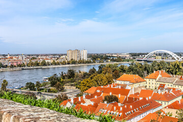 cityscape of Novi Sad from the historic vantage point of Petrovaradin, where ancient towers and...