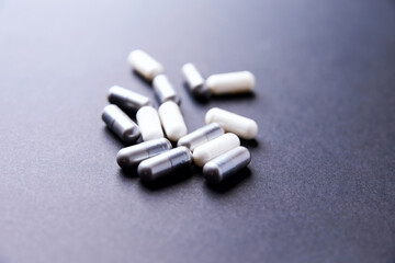 Creatine and BCAA amino acids capsules. Nutrition for bodybuilding. Fitness supplements on paper background. Soft focus. Copy space.