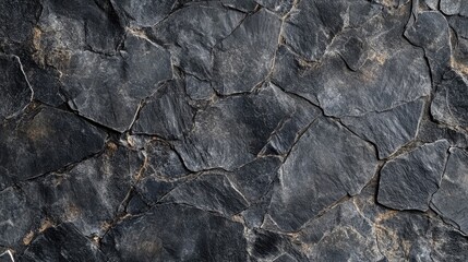 Aesthetic surface composed of rough black and light gray stones, creating a visually appealing texture and pattern. Ideal for design purposes with ample copy space.