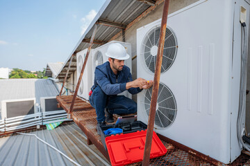 Air conditioner technician checking air conditioner operation.