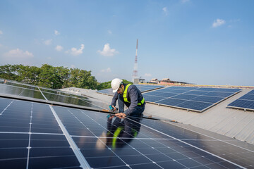 Engineer service check installation solar cell on the roof of factory. Silhouette technician inspection and repair solar cell on the roof of factory. Technology solar energy renewable.