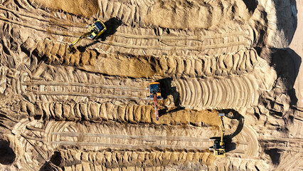Construction equipment on a construction site performs construction work