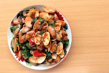Stir fried striped clams with basil, chilli paste, garlic and fresh chilies