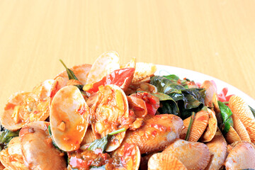 Stir fried striped clams with basil, chilli paste, garlic and fresh chilies