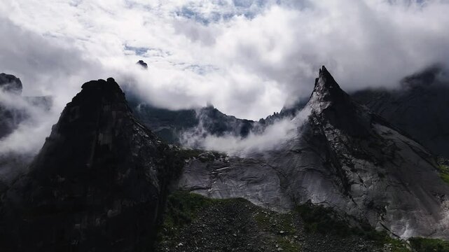 flying over rocks in the form of a parabola in the clouds