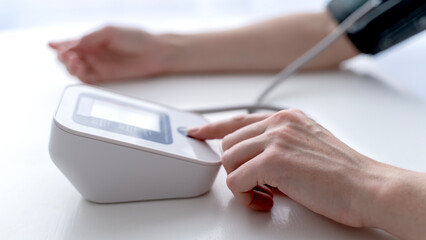 woman measuring blood pressure with a tonometer