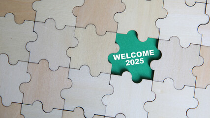 Fototapeta premium WELCOME 2025 word alphabet letters on puzzle as a background