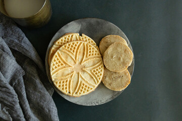 decorative cookies on a stoneware plate with gray linen napkin