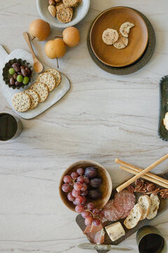 Charcuterie spread with fruit, nuts, cheese, and crackers on a table