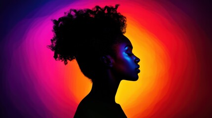 Silhouette of a woman against vibrant sunset.