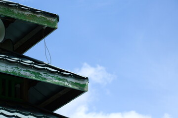roof with clouds and clear sky in the background