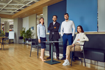 Team of successful professional business people meeting in modern office. Group of happy confident...