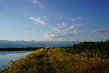Path along the Belizmata Dam with a backdrop of the Pirin Mountains, Bansko, Bulgaria
