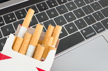 Close-up macro of cigarette on black keyboard