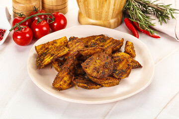 Golden baked potato Idaho with spices