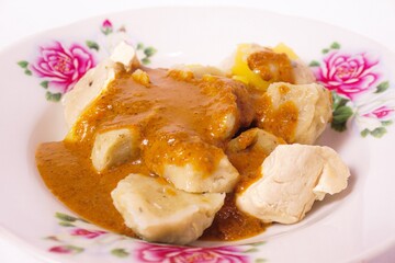 a siomay with fish balls, potatoes, peanut sausage, and tofu on a white background isolated