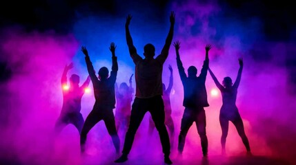 Silhouettes of Dancers Under Neon Lights at a Music Festival