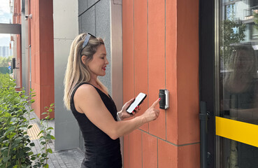 Door access control - young officer woman holding a key card to lock and unlock door for access...