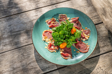 deer carpaccio with lamb's lettuce and roasted almonds