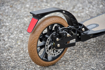 The rear wheel of the scooter has a disc and foot brake.