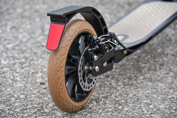 The rear wheel of the scooter has a disc and foot brake.