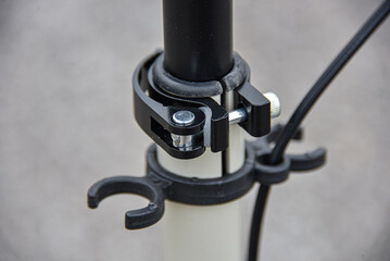 Clamp for adjusting the height of the handlebars on a scooter with holders.